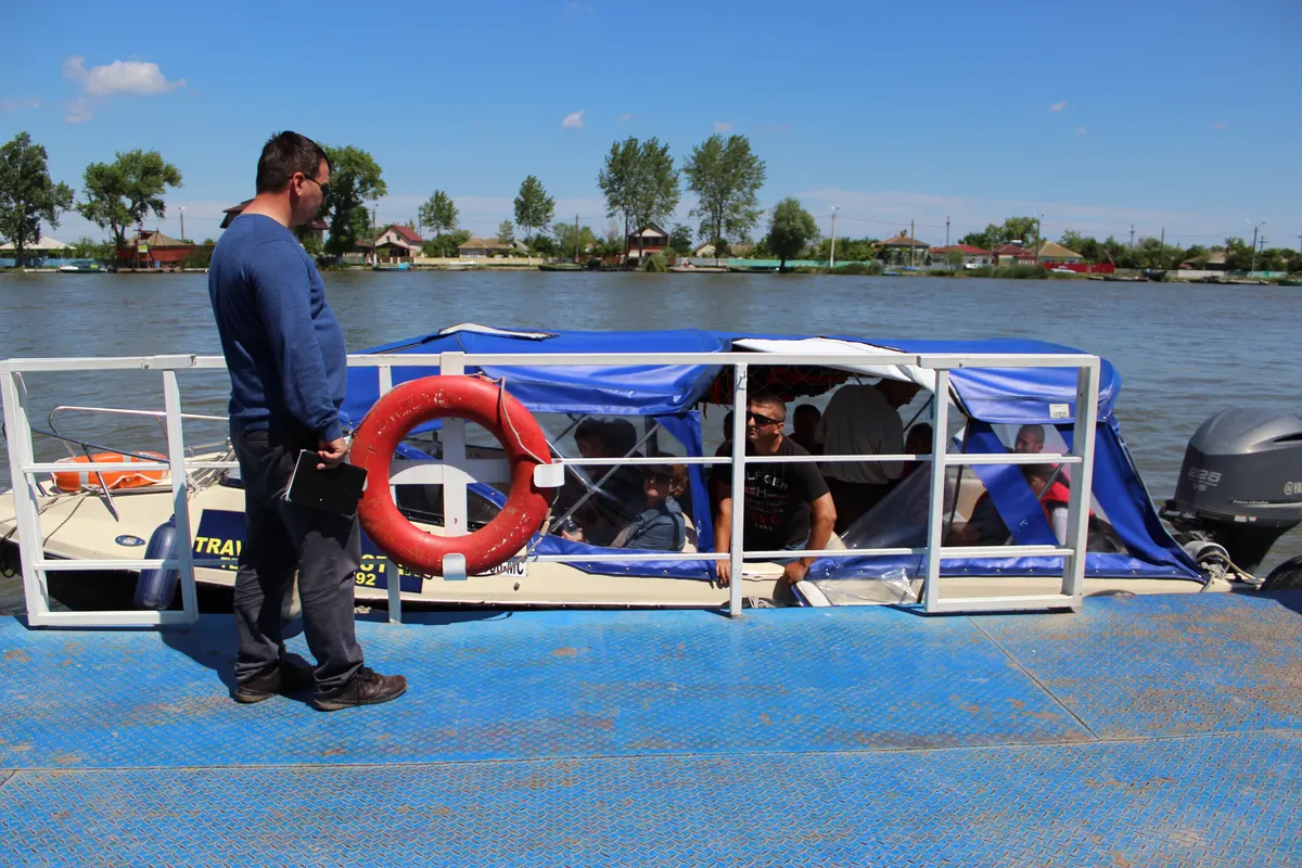 Travel Delta Star boat moored at the pontoon with passengers on board